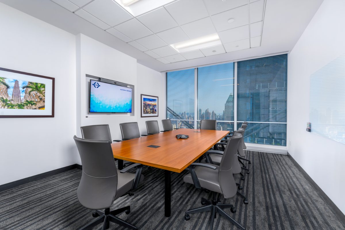 JAMS NY Conf Room 9 — 10-seat cherry table, grey leather chairs, JAMS display, Rockefeller Center and Brooklyn Bridge prints, NYT louvers on right.